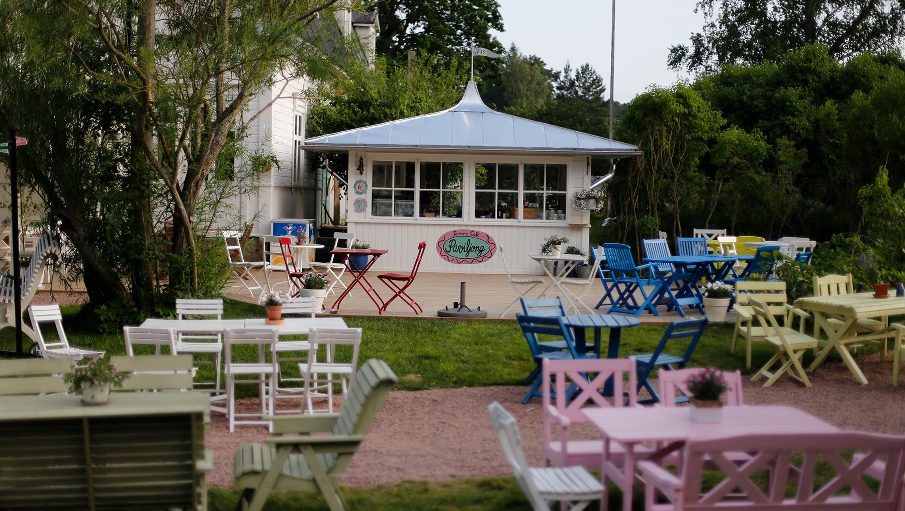 Colourful tables and chairs are set outside for customers at Farmors Cafe.