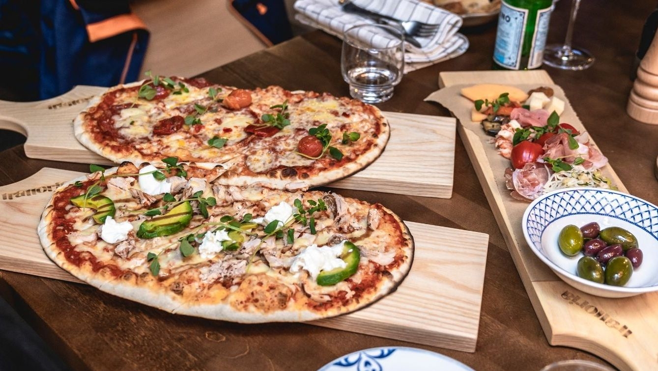 Trays of pizzas, olives, and antipasto at Restaurant Trattoria.