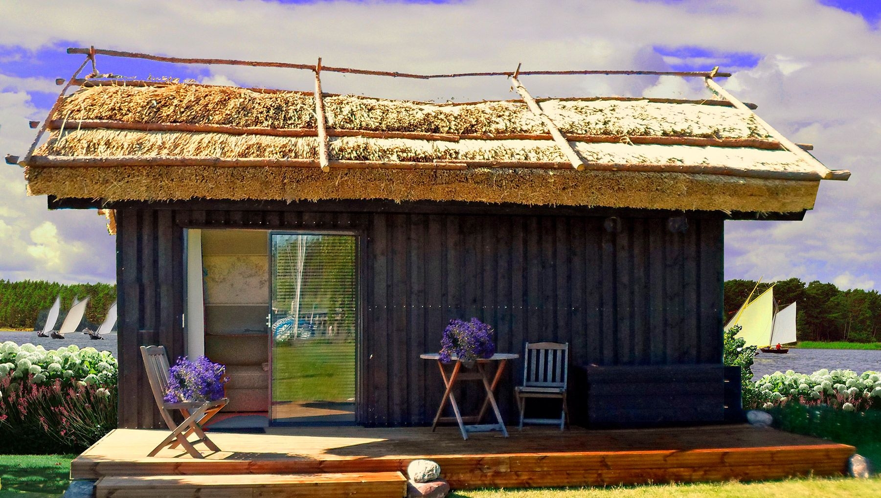 A thatched-roof boathouse at Peterzens, beside the water.