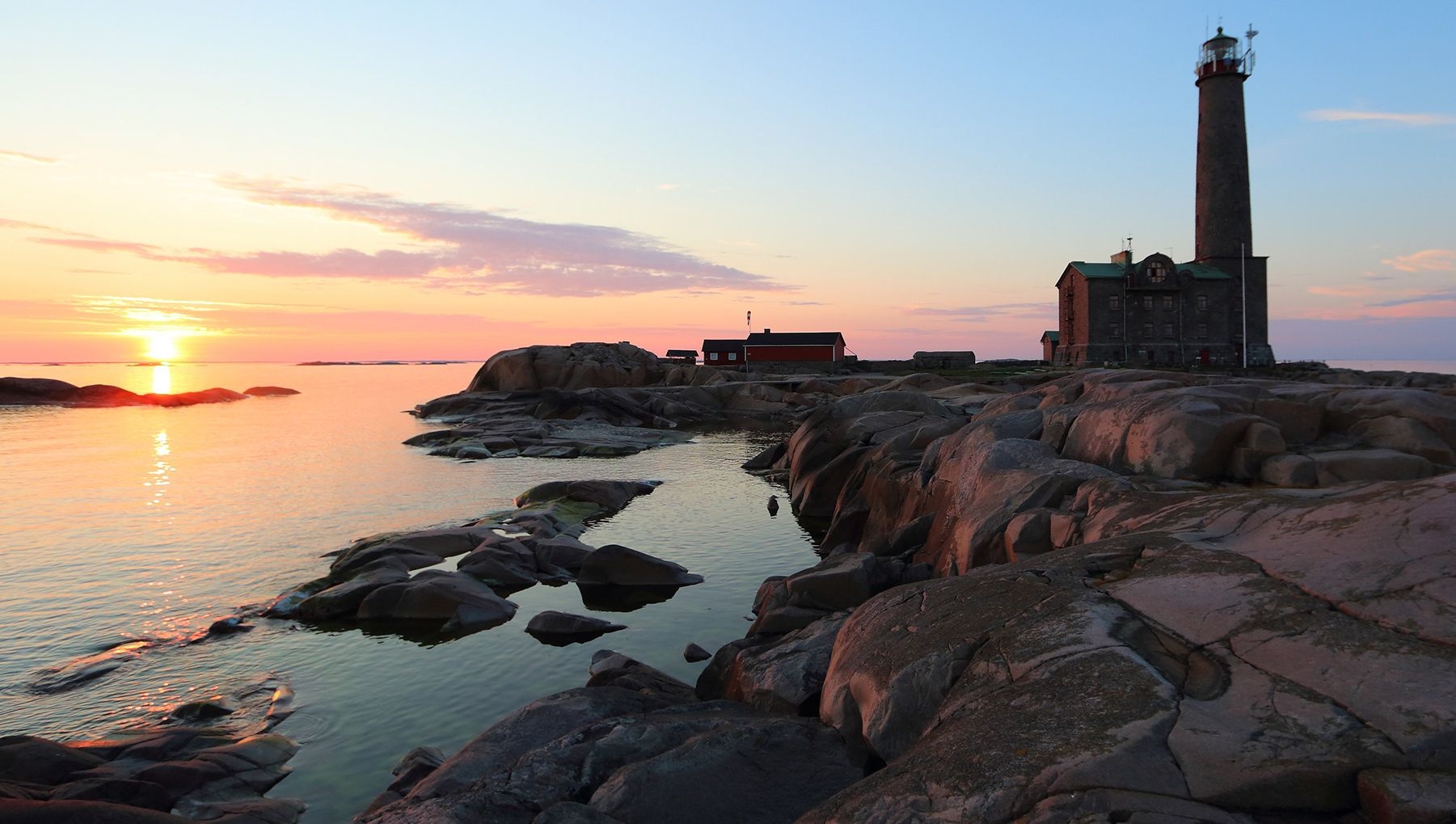 Bengtskär Lighthouse is bathed in light at sunset.