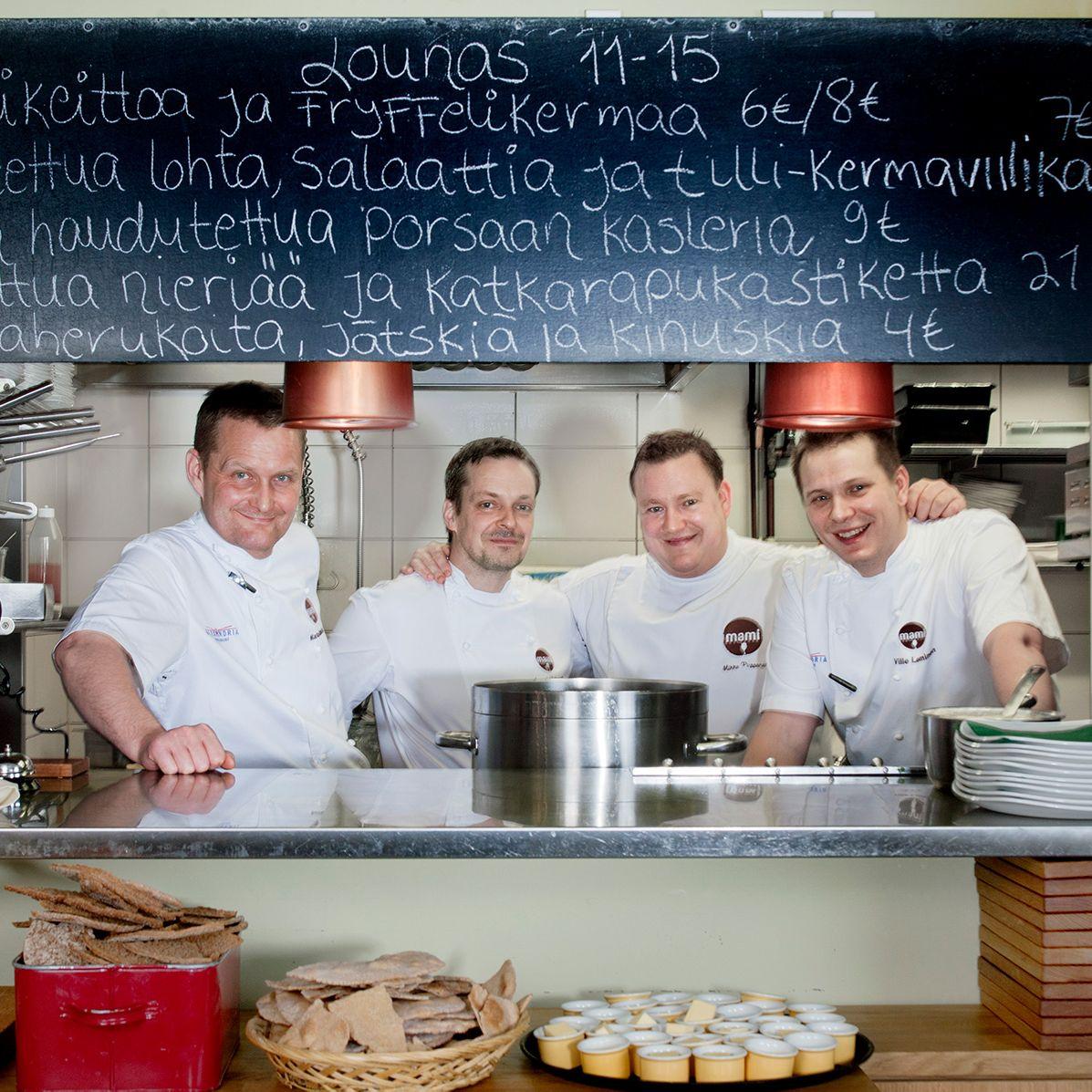 Four chefs behind the counter at Mami.