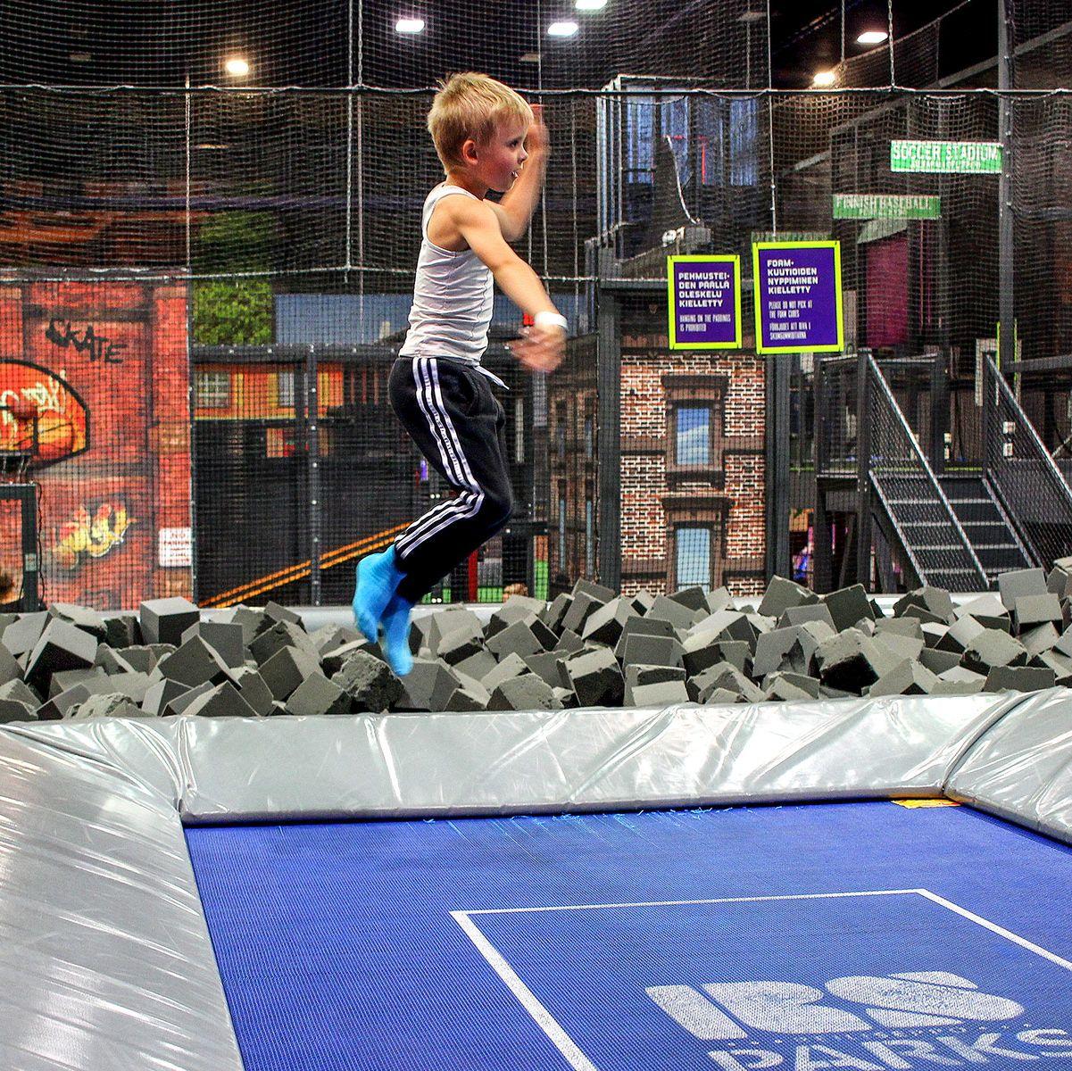 A young boy bounces on a trampoline at SuperPark Turku.