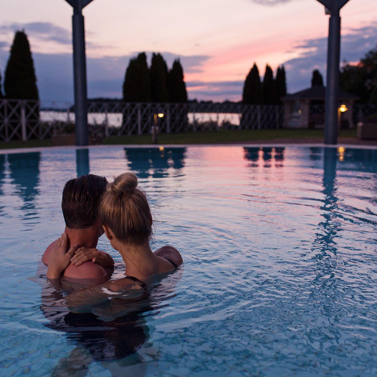 A couple enjoy the sunset at Naantali Spa Hotel & Resort from the pool.