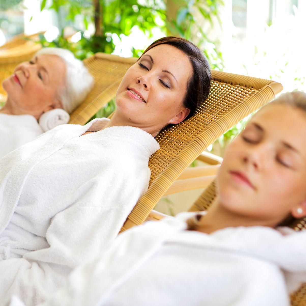 Three women relax in white bathrobes at the Ruissalo Spa Hotel.