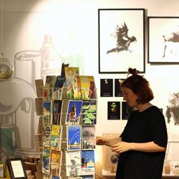 A shopper looks through the postcards on display at PUF Design.